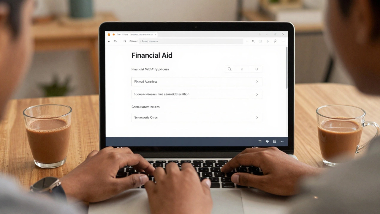 Student typing financial aid application on laptop with chai